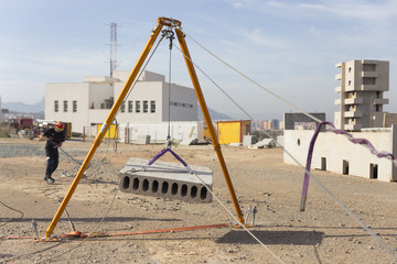 firefighter working with a mechanical tensioning steel cable