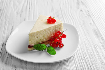 Delicious cheesecake with berries on table close up