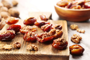 Walnut, date fruit on wooden table, close-up
