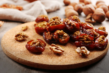 Walnut, date fruit on wooden table, close-up