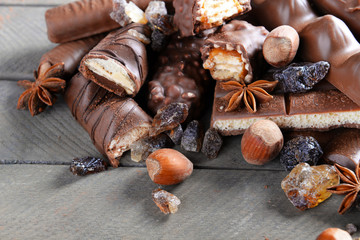 Chocolate sweets with powder on wooden background