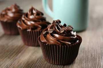 Chocolate cupcakes with drink on table