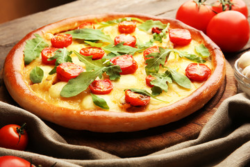 Pizza Margherita with arugula and vegetables, close-up