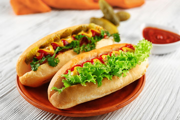 Delicious hot-dogs on white wooden table, close up