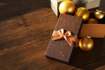 Box with Christmas toys on wooden background