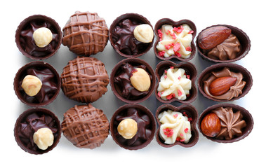 Delicious chocolate candies on white background