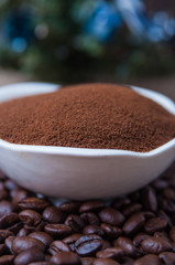 Coffee beans and instant coffee in saucer