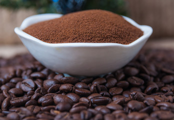 Coffee beans and instant coffee in saucer