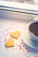 Declaration of love, a cup of coffee and cookies in the shape of
