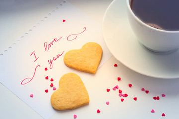 Declaration of love, a cup of coffee and cookies in the shape of