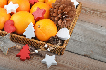 Orange in wickered tray with Christmas decor