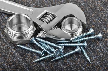Wrench, plumbing fitting and screw