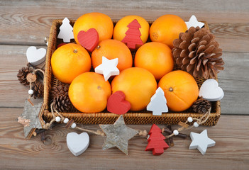 Orange in wickered tray with Christmas decor