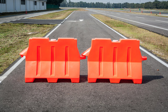 Orange plastic barrier lined up in rows 