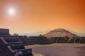 Stunning view to Teotihuacan pyramids in orange sunset light 