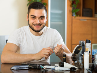 Man doing manicure at home