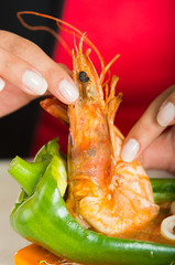 Young woman eating a big delicious shrimp