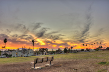 Fototapeta premium Park bench offers best seating for sunset.