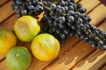 Fresh berry or grape and orange background, healthy fruit concept, popular fruit or market fruit.
