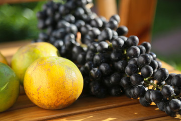 Fresh berry or grape and orange background, healthy fruit concept, popular fruit or market fruit.
