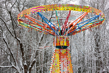 carousel in amusement park under snow