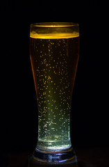 Still Life with a draft beer by the glass on dark background, ce