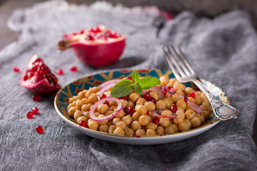 Traditional eastern chickpea salad with pomegranate, red onion and spices