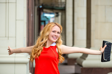 portrait of happy woman with arms outstretched smiling