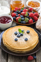crepes, fresh berries and jams, vertical, close-up