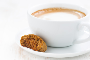cup of cappuccino and almond cookie, selective focus