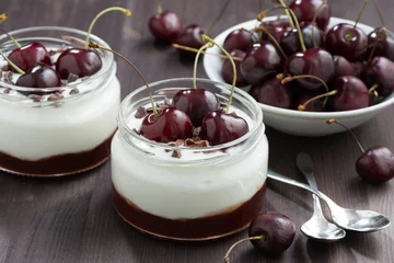 Rolgordijnen dessert with cream and jam in glass jar on wooden table, closeup © cook_inspire