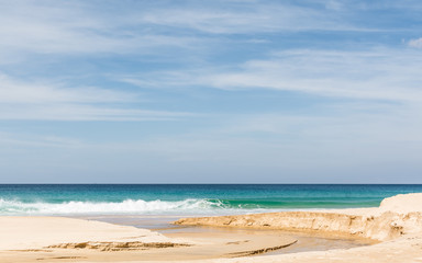 Fototapeta na wymiar Beach, sea and cloudy blue sky