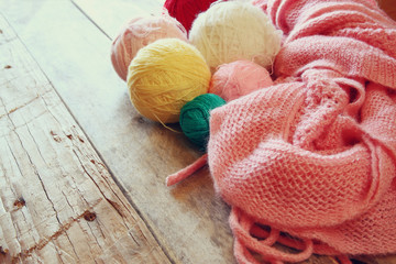 colorful yarn balls of wool on wooden table
