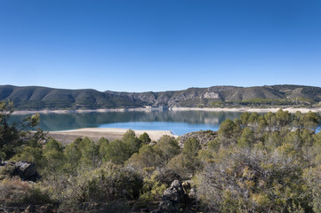 Obraz premium Views of Buendia Reservoir, in the upper waters of the river Tagus, Cuenca, Spain. The surface area of the reservoir measures 8,194 hectares, and it can hold a total of 1,638 cubic hectometres