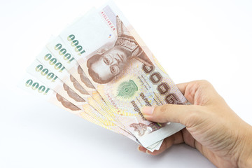 The Thai baht in hand