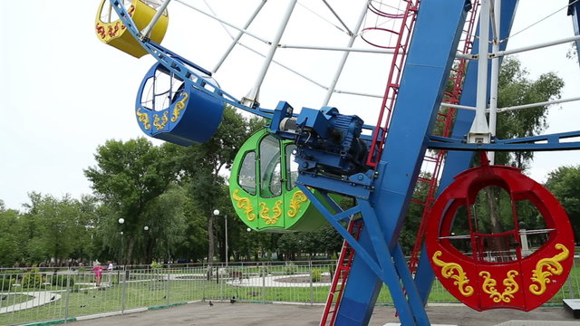 Ferris wheel in motion in the amusement park

