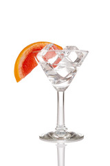 Glass with ice cubes and orange. 