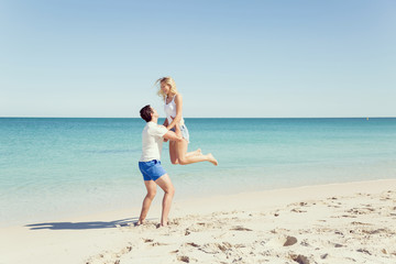 Happy couple  jumping on beach vacations