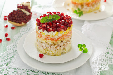 Layered salad from vegetables on the holiday table