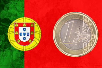 Obraz premium One euro coin on the flag of Portugal as background