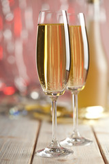Two glasses of champagne on red background