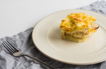 Potato casserole with meat on the wooden table