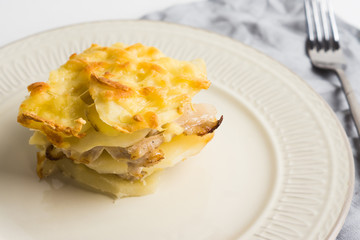 Potato casserole with meat on the wooden table