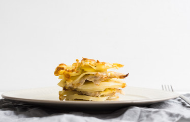 Potato casserole with meat on the wooden table