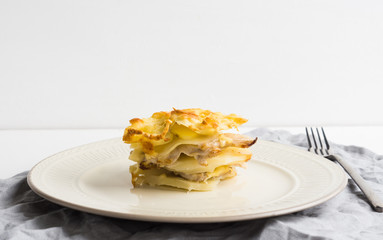 Potato casserole with meat on the wooden table