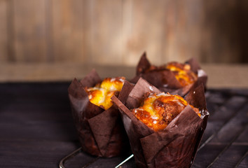 Muffins witch chocolate on wooden background. 