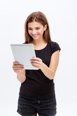 Naklejka premium Happy lovely cute young woman using tablet computer