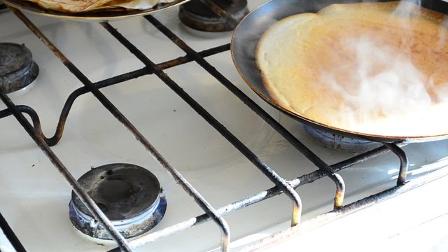 Preparation of pancakes in kitchen