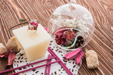 spa stuff on wooden background: candle, aroma