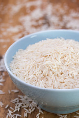 rice on blue bowl on brown background